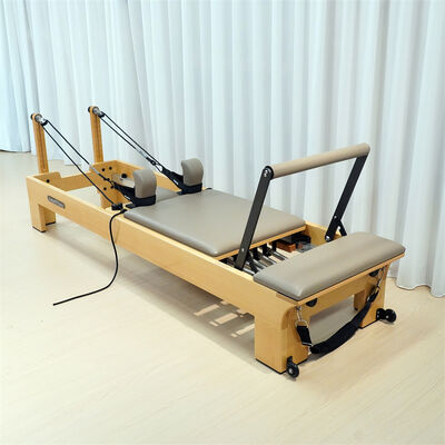 Quality Premium Beech Wood Pilates Reformer with Built-in Footbar and Adjustable Spring Resistance for Commercial Use factory