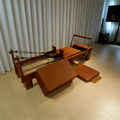 Qualité Lit réformateur de pilates en bois Wenge, ensemble complet avec pied de pied réglable et accessoires de pilates
Équipement de remise en forme de pilates en bois haut de gamme avec système de tour pour utilisation commerciale Usine